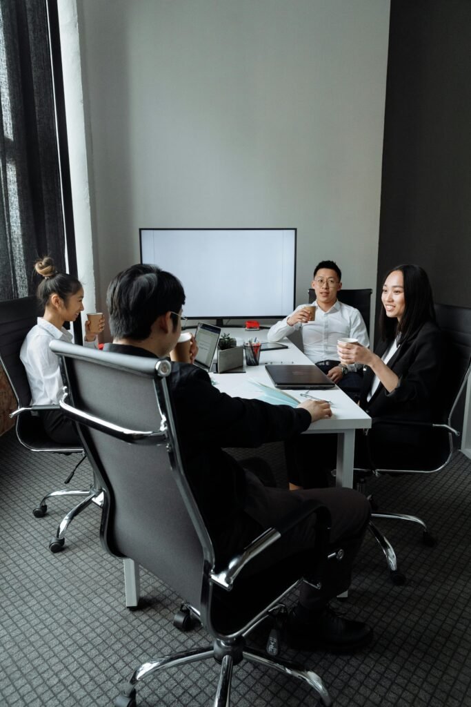 pexels-photo-7652135-7652135 Group of professionals engaged in a collaborative meeting in a modern office setting.