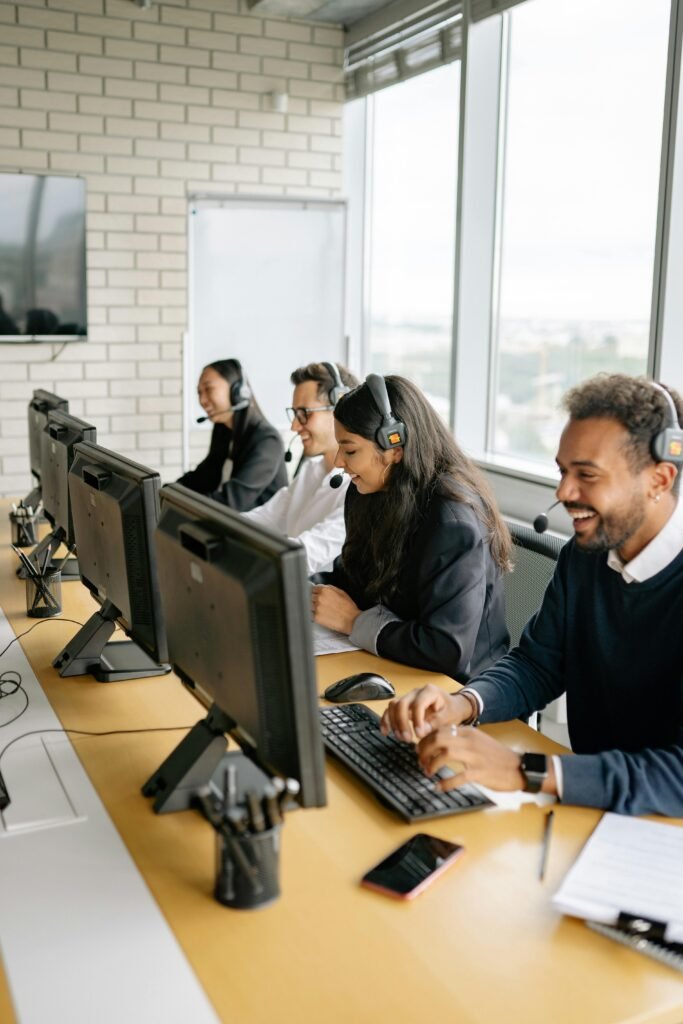 pexels-photo-8867265-8867265 A diverse group of call center employees working together at desks in a modern office.